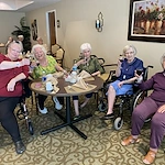 Plantation Oaks Assisted Living & Memory Care in High Springs, FL, residents socializing and enjoying wine