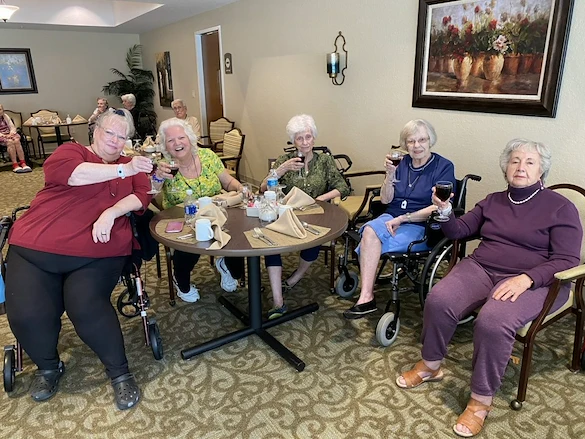 Plantation Oaks Assisted Living & Memory Care in High Springs, FL, residents socializing and enjoying wine