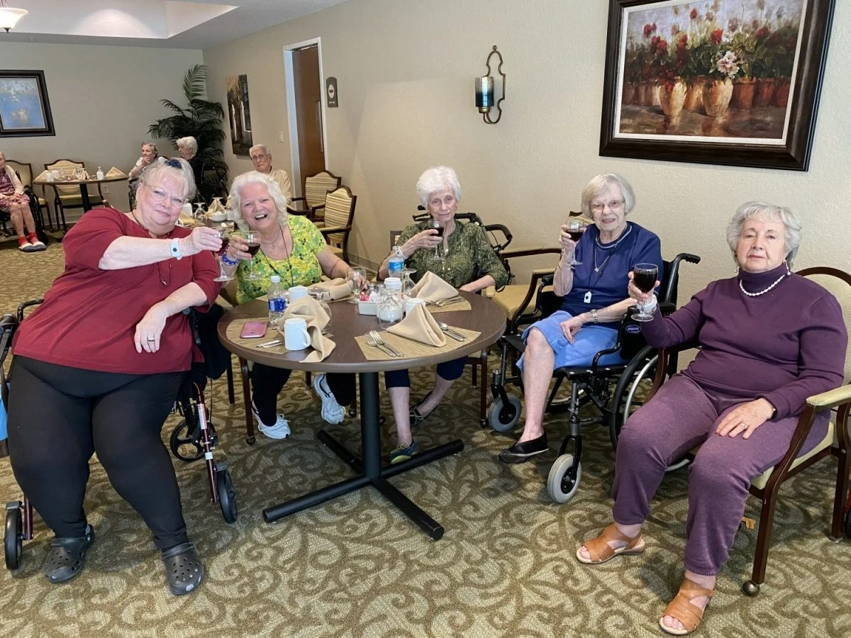 Plantation Oaks Assisted Living & Memory Care in High Springs, FL, residents socializing and enjoying wine