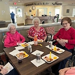 Pathfinder Senior Living in Fremont, NE, residents enjoy dining together and socializing