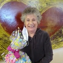 The Carriage House Gracious Retirement Living Hawthorn Senior Independent Living in Oxford, Florida resident holding a gift basket