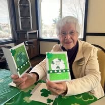 The Rio Grande Gracious Retirement Living Hawthorn Senior Independent Living in Rio Rancho resident playing a St. Patrick's Day themed card game