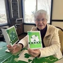 The Rio Grande Gracious Retirement Living Hawthorn Senior Independent Living in Rio Rancho resident playing a St. Patrick's Day themed card game