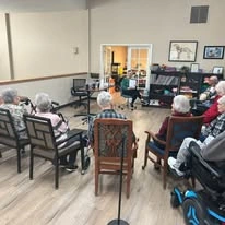 Avamere at South Hill senior living community offering assisted living and respite care in Spokane, WA, residents listening to a story being read