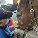 Chelsea Place Memory Care petting a horse