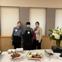 Ascension Living Alexian Village Tennessee Senior Living, independent living, assisted living, memory care, and continuing care retirement community (CCRC) in Signal Mountain, TN, staff members standing by gourmet food