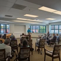 Ascension Living Bethlehem Woods Village senior living community offering independent living, assisted living, and memory care in La Grange Park, IL, residents listening to a speaker