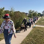 Meadowlark Estates Gracious Retirement Living Hawthorn Senior Independent Living in Lawrence, Kansas residents out for a walk