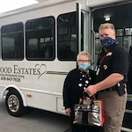 Linwood Estates Gracious Retirement Living Hawthorn Senior Independent Living in Lawrenceville, Georgia resident being helped by staff out of the transportation bus