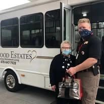 Linwood Estates Gracious Retirement Living Hawthorn Senior Independent Living in Lawrenceville, Georgia resident being helped by staff out of the transportation bus