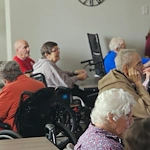 Addolorata Villa, continuing care retirement community offering independent living, assisted living, and memory care in Wheeling, IL, residents engaged in a presentation