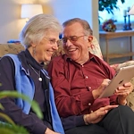 John Knox Village Senior Living CCRC near Kansas City, MO resident couple looking at a tablet