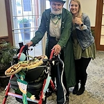 Allisonville Meadows Assisted Living offering assisted living, memory care, and respite care in Fishers, IN, resident in festive attire smiling with a staff member