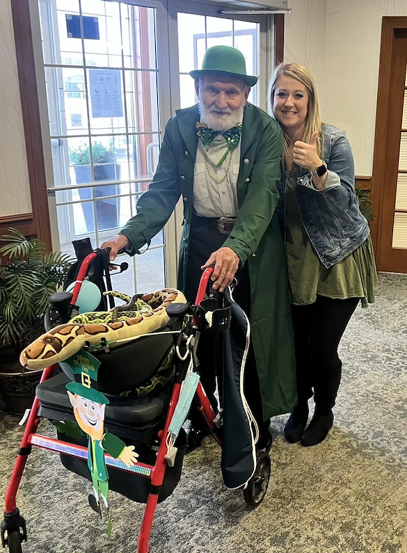 Allisonville Meadows Assisted Living offering assisted living, memory care, and respite care in Fishers, IN, resident in festive attire smiling with a staff member