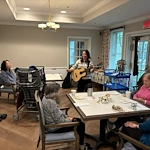 Charter Senior Living of Dedham in Dedham, MA, residents enjoying engaging entertainment