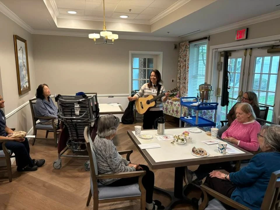 Charter Senior Living of Dedham in Dedham, MA, residents enjoying engaging entertainment