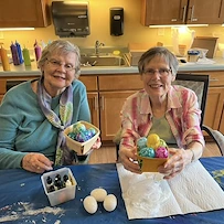 Two Waters of Plymouth residents showing off their decorative easter basket creations