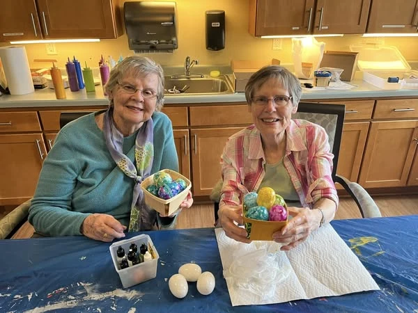 Two Waters of Plymouth residents showing off their decorative easter basket creations