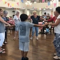 Colonial Harbor Gracious Retirement Living Hawthorn Senior Independent Living in Yorktown, Virginia residents playing a game with kids in the community