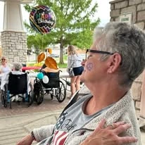 Ascension Living Via Christi Village Manhattan Senior Living in Manhattan, Kansas resident with face paint at a birthday party
