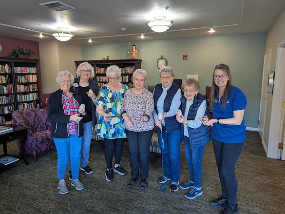 Chateau Bothell Landing in Bothell, WA, smiling residents with Easter eggs