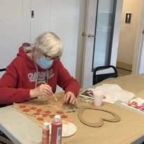 Stone Lodge Gracious Retirement Living Hawthorn Senior independent Living in Bend, Oregon resident painting a heart