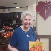 El Dorado Estates Gracious Retirement Living Hawthorn Senior Independent Living in El Dorado Hills, California resident showing painting of pumpkin