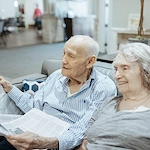 Seniors reading newspaper