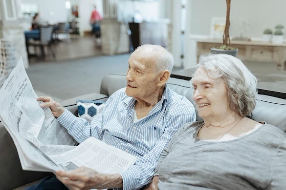 Seniors reading newspaper