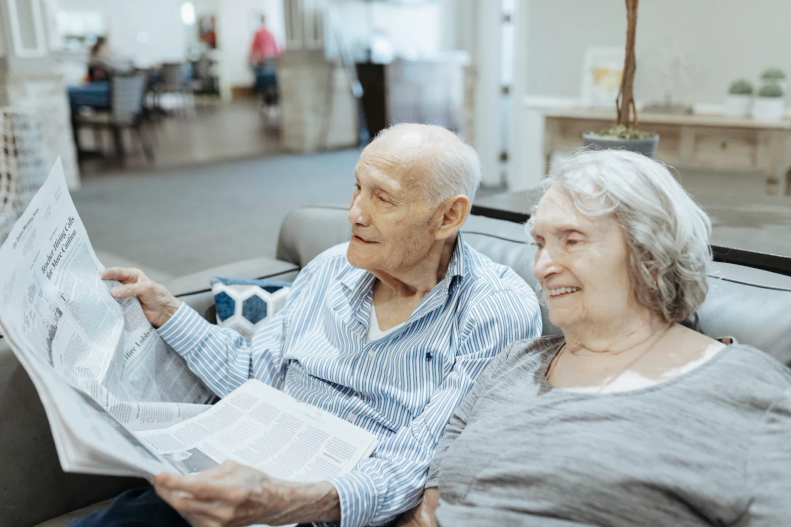 Seniors reading newspaper