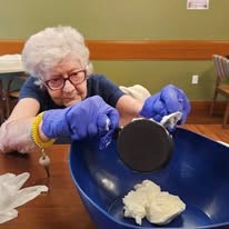 Ascension Living Lakeshore at Siena Memory Care Senior Living in Racine, Wisconsin resident baking