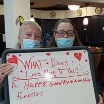 Heatherwood Gracious Retirement Living Hawthorn Senior Independent Living in Tewksbury, Massachusetts residents holding a Valentine's Day sign