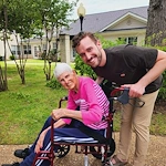 Montclair Park Assisted and Independent Senior Living in Shreveport, LA resident in a wheelchair being pushed by a staff member