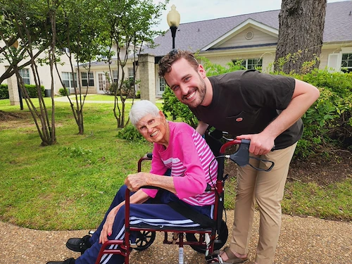 Montclair Park Assisted and Independent Senior Living in Shreveport, LA resident in a wheelchair being pushed by a staff member