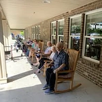 The Lodge at Wake Forest Gracious Retirement Living Hawthorn Senior Independent Living in Wake Forest, North Carolina residents sitting on the front patio