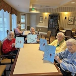 Residents of Viva Senior living showing off their paintings