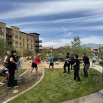 Ovation Sienna Hills Senior Living in Washington, Utah residents residents have an outdoor water balloon fight