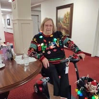 Summerville Estates Gracious Retirement Living Hawthorn Senior Independent Living in Summerville, South Carolina resident wearing an ugly Christmas sweater