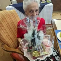 The Peaks At Santa Rita Active Retirement Living Hawthorn Senior Independent Living in Green Valley, Arizona resident holding a gift basket