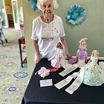 Wesley Manor Assisted Living Community offering assisted living and continuing care retirement community (CCRC) services in Louisville, KY, senior woman standing by State Fair Barbie outfits project