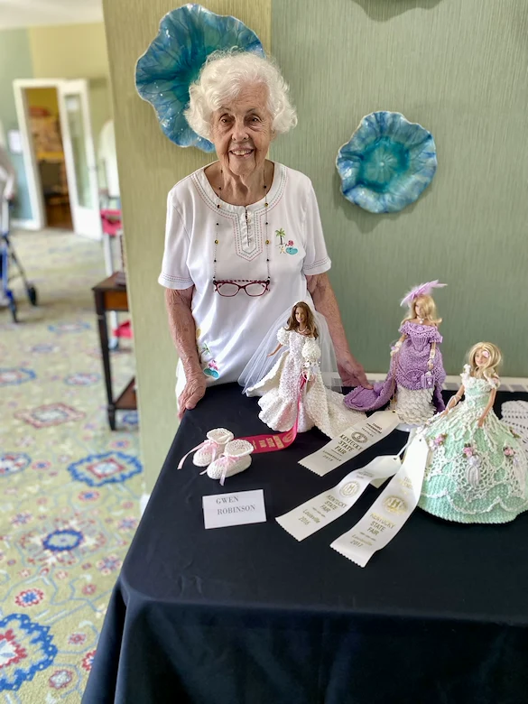 Wesley Manor Assisted Living Community offering assisted living and continuing care retirement community (CCRC) services in Louisville, KY, senior woman standing by State Fair Barbie outfits project