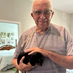 Calumet Trace - a Charter Senior Living Community resident loving a visit from puppies