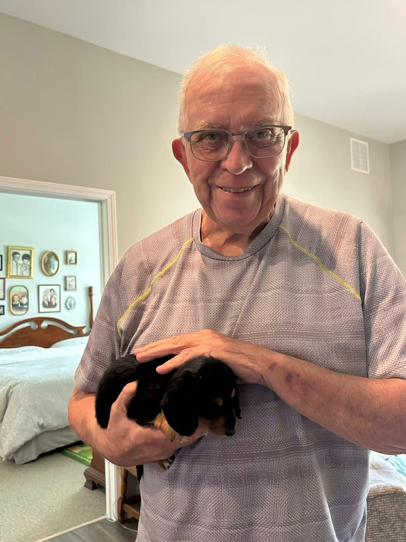 Calumet Trace - a Charter Senior Living Community resident loving a visit from puppies