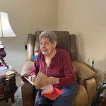 Ascension Living Via Christi Village Georgetown Senior Independent Living in Wichita, Kansas resident reading a card