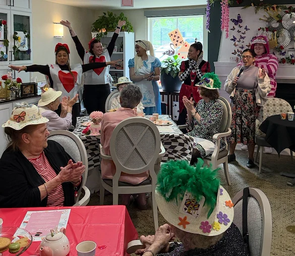 Chateau Valley Center in Renton, WA, residents enjoying entertainment during themed tea party