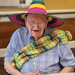 Montclair Park Assisted and Independent Senior Living in Shreveport, LA resident wearing a colorful hat and scarf