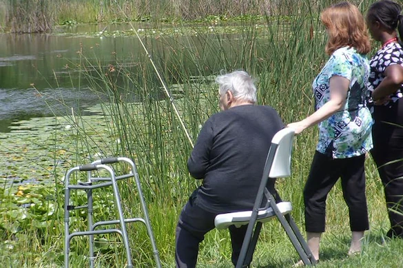 Porter Place Assisted Senior Living Memory Care in Tinley Park, IL resident fishing in a pond