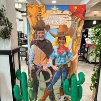 The Savoy Gracious Retirement Living Hawthorn Senior Independent Living in Winter Springs, Florida residents with Wild West photo backdrop