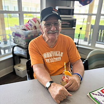 Charter Senior Living of Cleveland smiling resident during happy hour