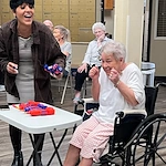 Whealdon Estates by Barclay House senior living community offering independent living in Baton Rouge, LA, excited resident smiling during fun community game
